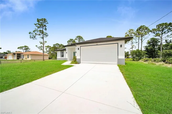 View of front of home featuring a garage and a front lawn