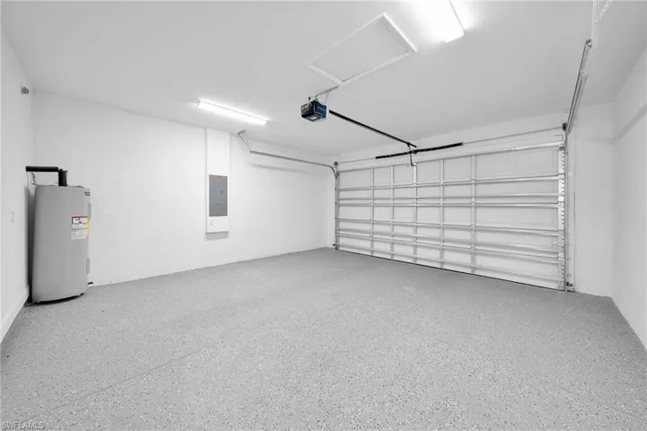 Garage with water heater and a garage door opener