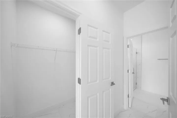 Corridor featuring light tile floors