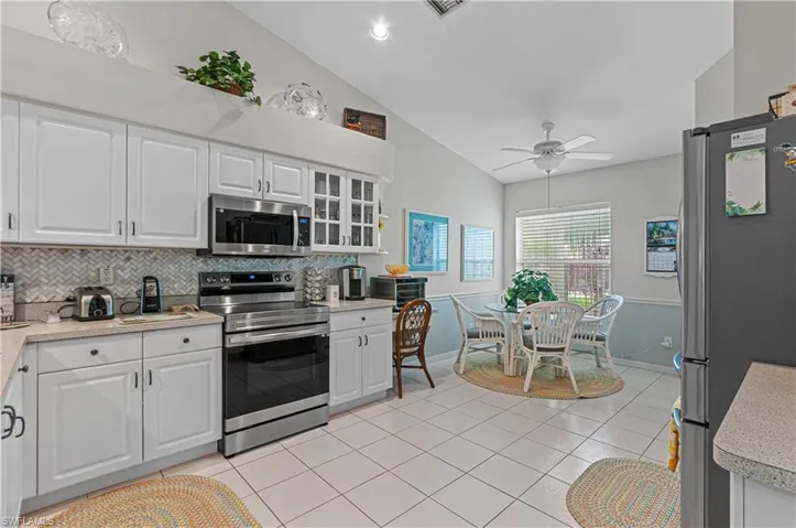 Large kitchen with desk area and breakfast area, light and bright.