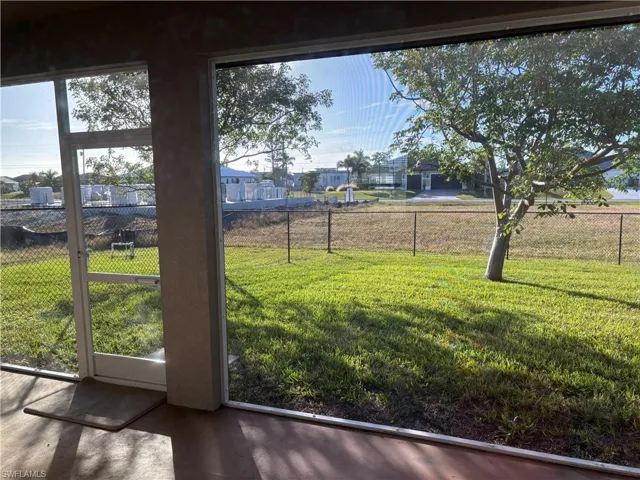 Screened lanai looking out to the fenced back yard