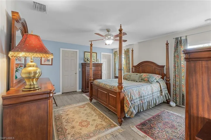 Bedroom with ceiling fan and light hardwood / wood-style flooring