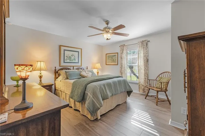 Bedroom with ceiling fan and light hardwood / wood-style floors