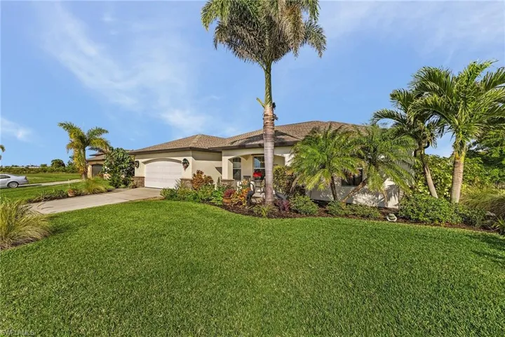Mediterranean / spanish-style house featuring a front yard and a garage