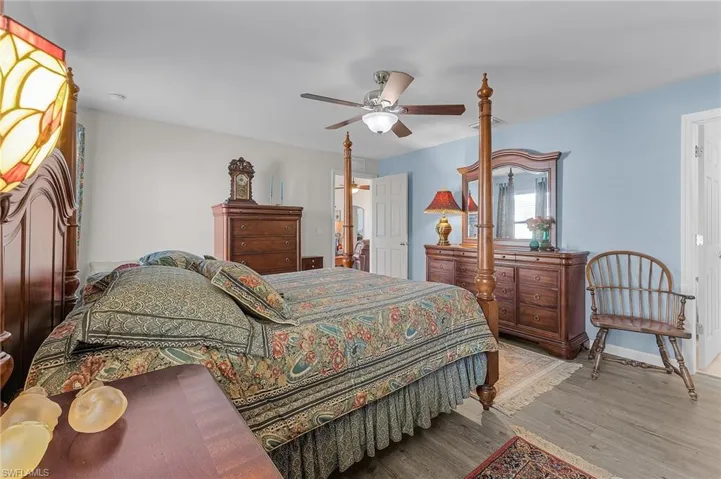 Bedroom with light hardwood / wood-style floors and ceiling fan