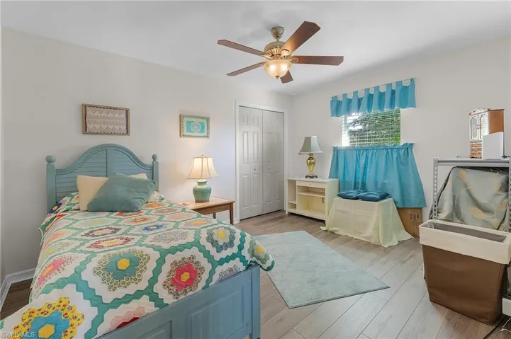 Bedroom featuring a closet, light hardwood / wood-style flooring, and ceiling fan