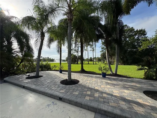 View of property's community featuring a yard and a patio