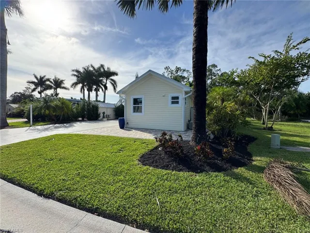 View of side of property with a lawn