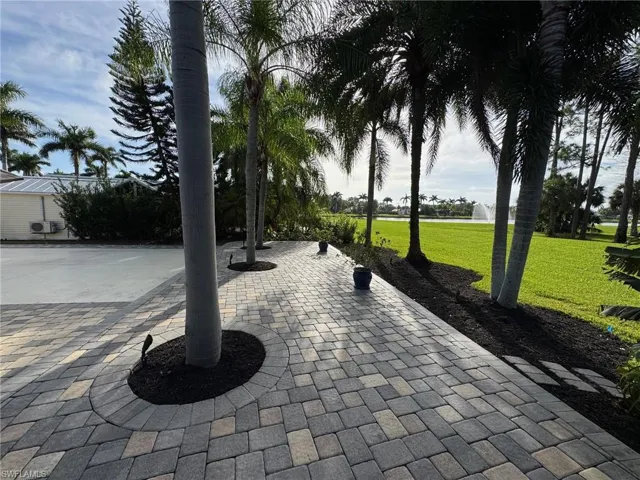 View of property's community with a lawn