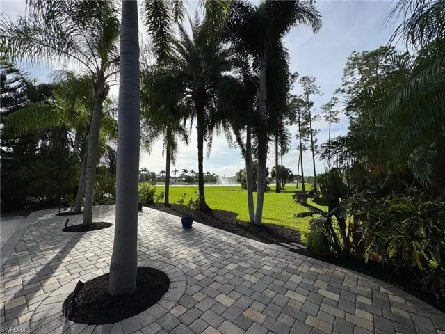 View of home's community with a yard