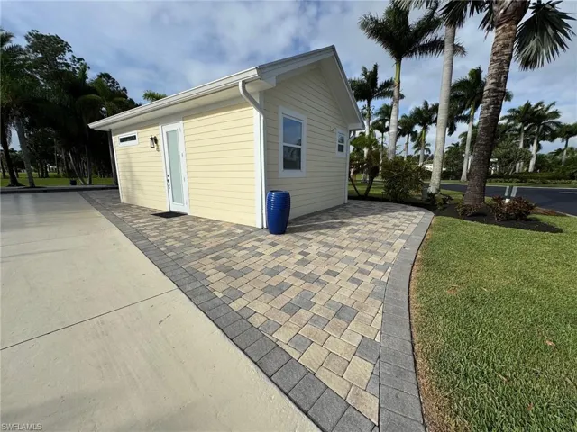 View of outbuilding with a lawn