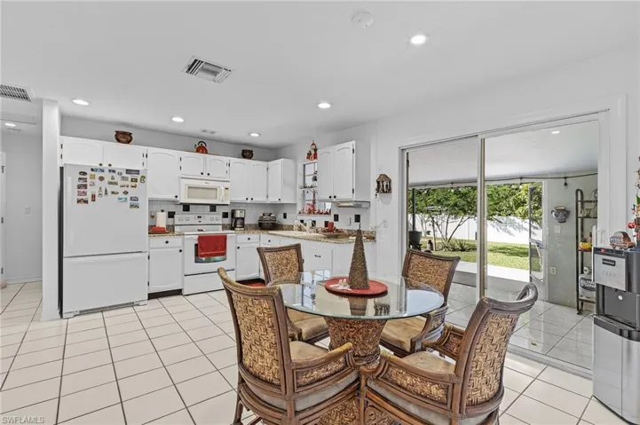 Tiled dining area featuring sink