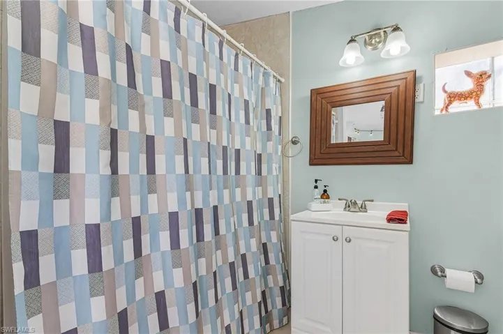 Bathroom featuring vanity and a shower with shower curtain