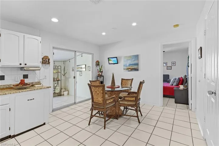 Dining room with light tile patterned flooring