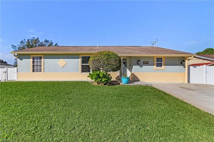 Single story home featuring a front lawn