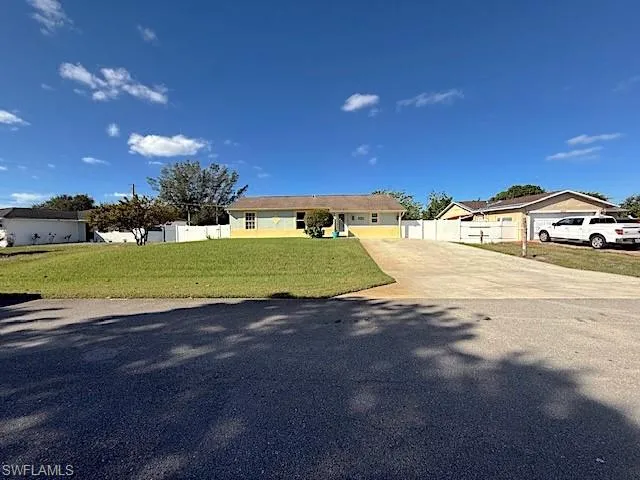 Ranch-style house featuring a front lawn