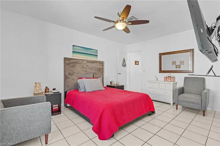 Tiled bedroom with ceiling fan