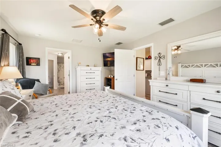Bedroom with ceiling fan and ensuite bathroom