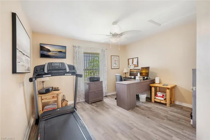 Office area with ceiling fan and light wood-type flooring