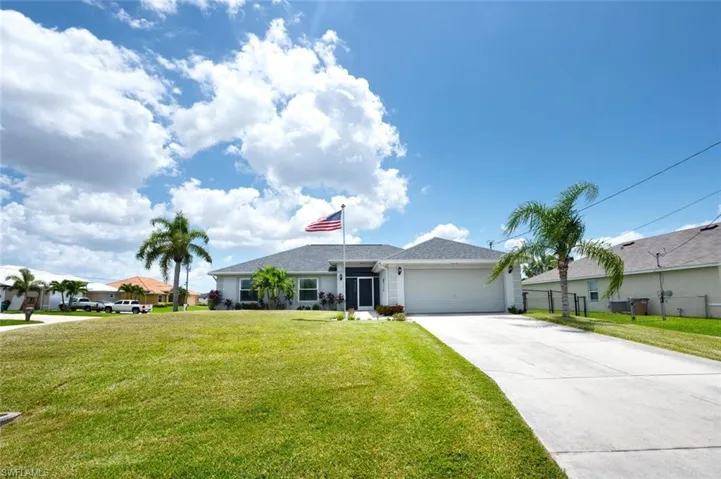 Single story home with a front yard and a garage