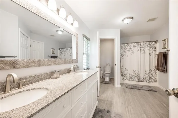 Bathroom with double vanity and toilet