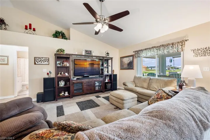 Living room with ceiling fan and vaulted ceiling