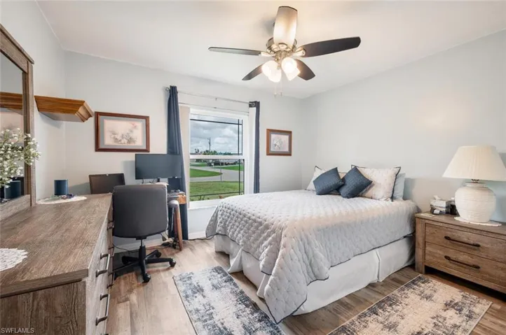 Bedroom with ceiling fan and light wood-type flooring