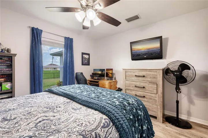 Bedroom with ceiling fan and hardwood / wood-style flooring