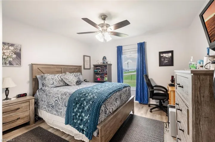 Bedroom with ceiling fan and light hardwood / wood-style floors