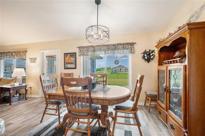 Dining space featuring light hardwood / wood-style flooring and an inviting chandelier