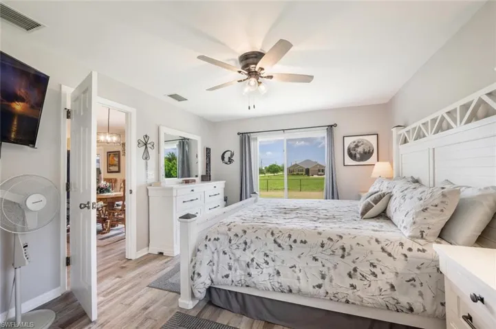 Bedroom with ceiling fan and light hardwood / wood-style floors