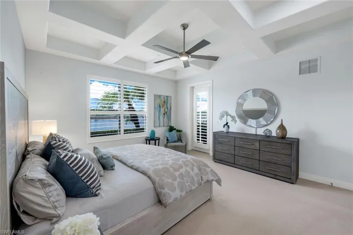 PRIMARY ENSUITE WITH GLASS DOOR TO LANAI AND BREATHTAKING WATER VIEWS WITH PALM TREE