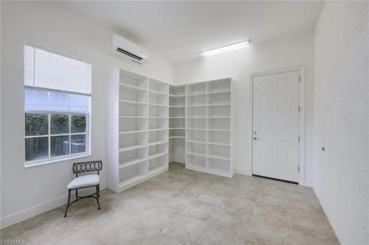 FLEX ROOM/DIVIDED TANDEM GARAGE UNDER AIR WITH PERMITTED A/C AND BUILT IN SHELVING FOR CONVENIENT STORAGE