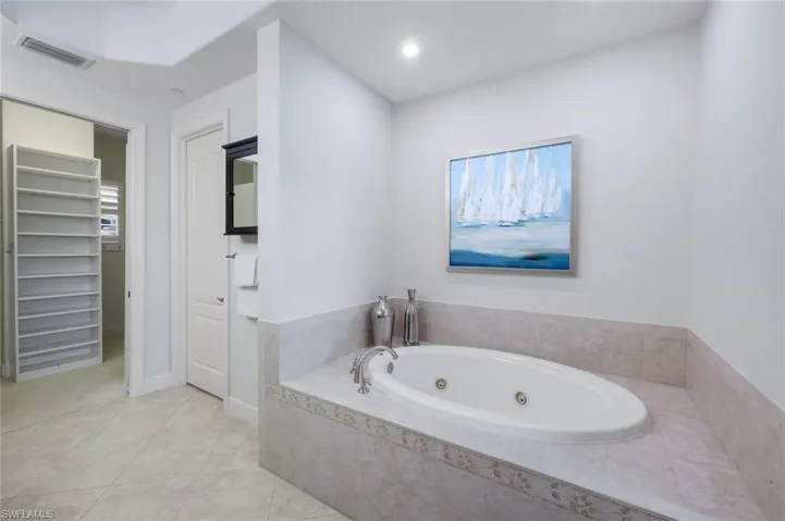 PRIMARY ENSUITE WITH JETTED TUB, WATER CLOSET AND CUSTOM CLOSET