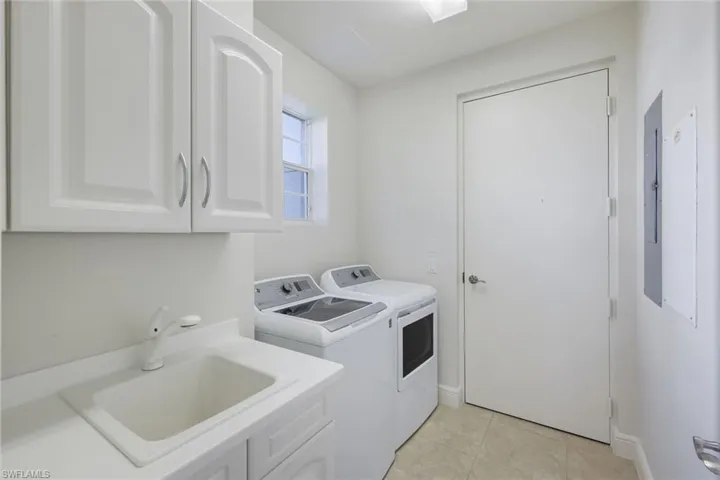 SEPARATE LAUNDRY ROOM WITH UTILITY SINK AND EXTRA CABINETS