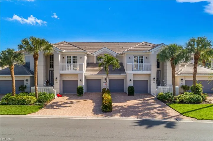 Building exterior recently re-painted with new roof installed and roadway resurfaced. Cypress Hammock is meticulously maintained. Entry to unit shown with red arrow.