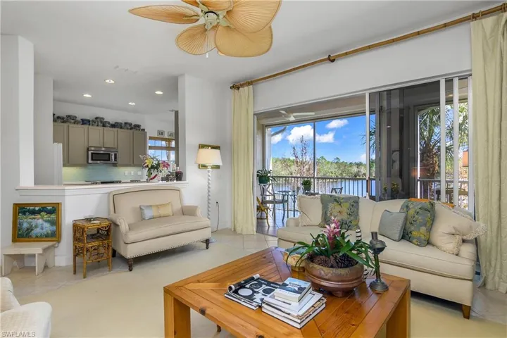 Open living area with modern visibility from kitchen to family room. Sliding doors lead to east facing lanai.