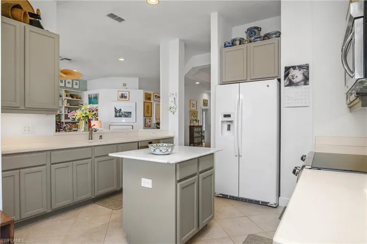 Modern Chef's kitchen overlooking family room...new countertop on center island, cabinets painted and new backsplash at kitchen counters.