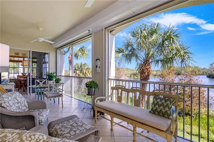 Spacious lanai with stunning lake view, tile flooring...note electrically powered hurricane shutters protection at top.