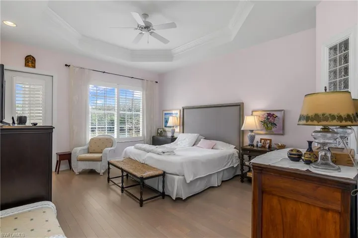 Master bedroom suite, wood flooring, large area for king-size bed. Note tray ceiling.
