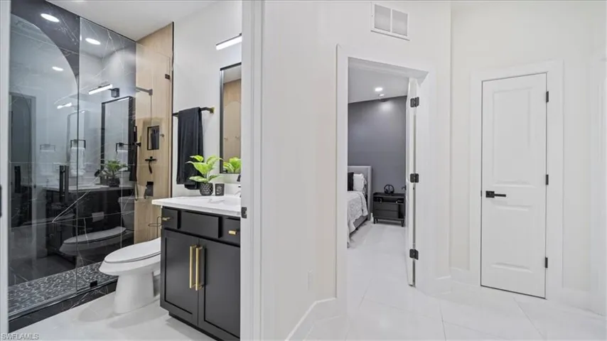 Full bathroom featuring vanity, a shower stall, recessed lighting, light tile patterned floors, and ensuite bath