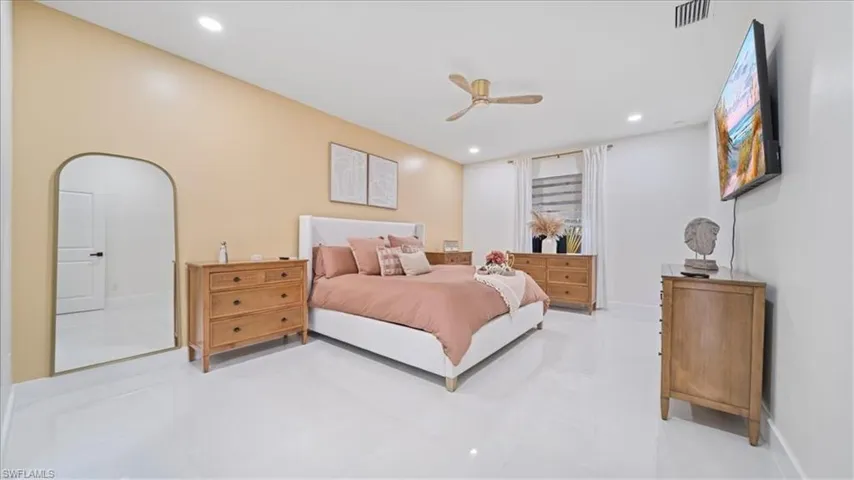 Bedroom with a ceiling fan and recessed lighting