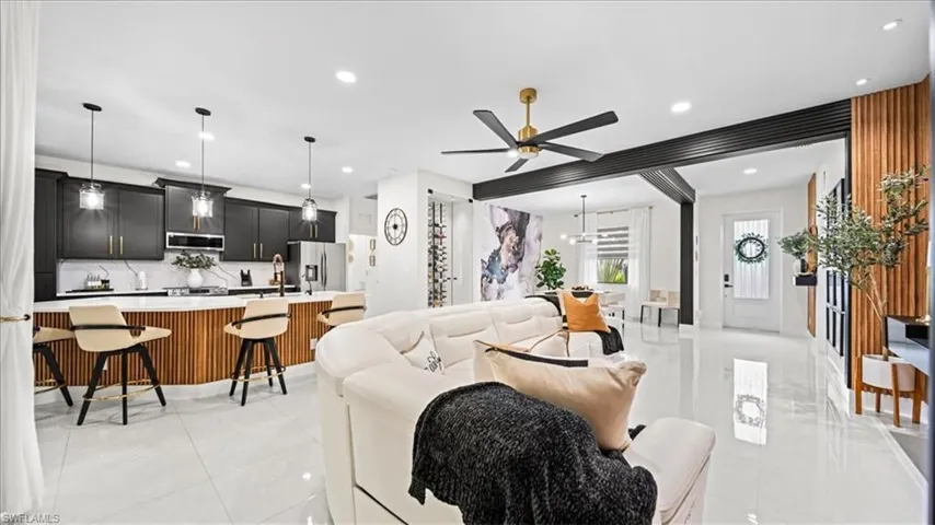 Living room with recessed lighting, ceiling fan, and light tile patterned floors