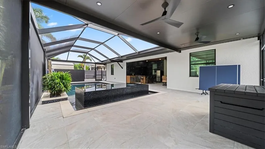 View of patio / terrace with ceiling fan, a sunroom, and a lanai
