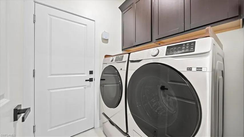 Laundry area with washing machine and dryer and cabinet space