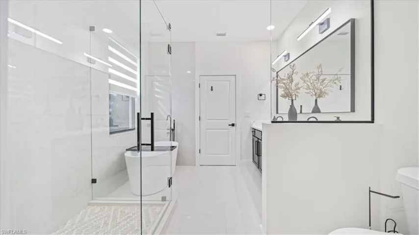Full bath with a soaking tub, vanity, a shower stall, recessed lighting, and light tile patterned floors