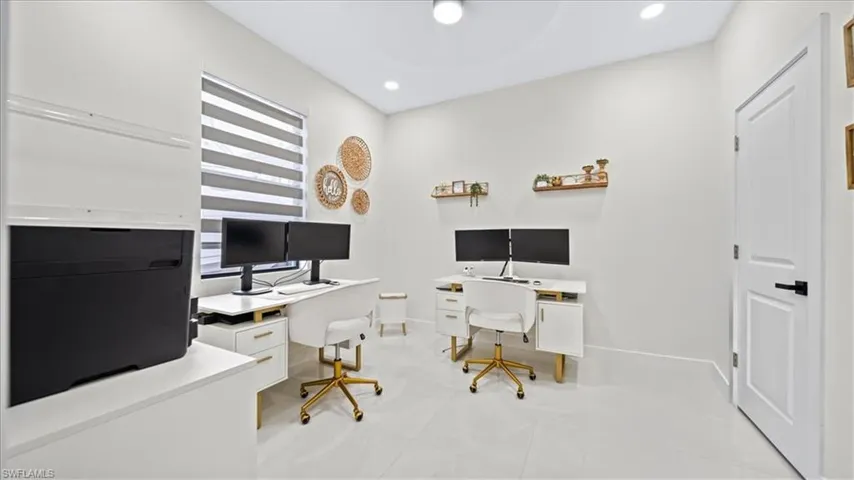 Home office with recessed lighting and baseboards