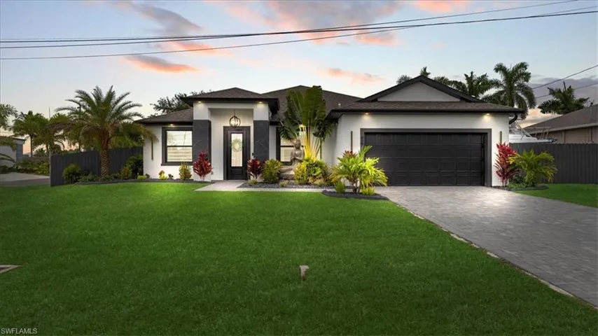 View of front of home featuring stucco siding, decorative driveway, an attached garage, and roof with shingles