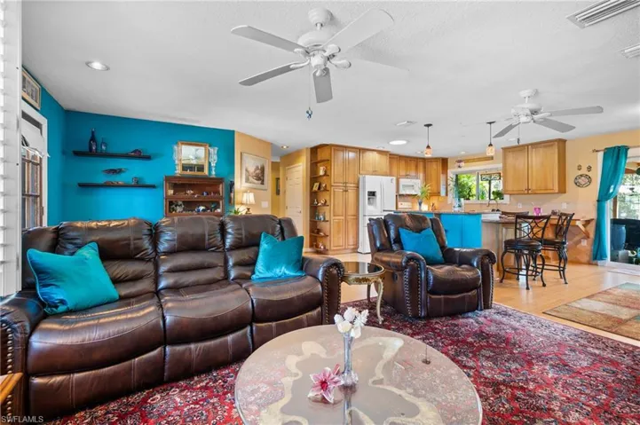Open-concept living space featuring recessed lighting and ceiling fans