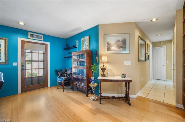 Warm wood-finish flooring extending into a brightly lit space